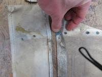 passenger side position of the rear corner rivet hole in the rag-PVC-headliner