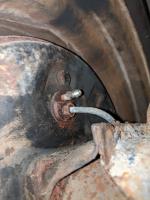Rear brake hard line connection to rear wheel
